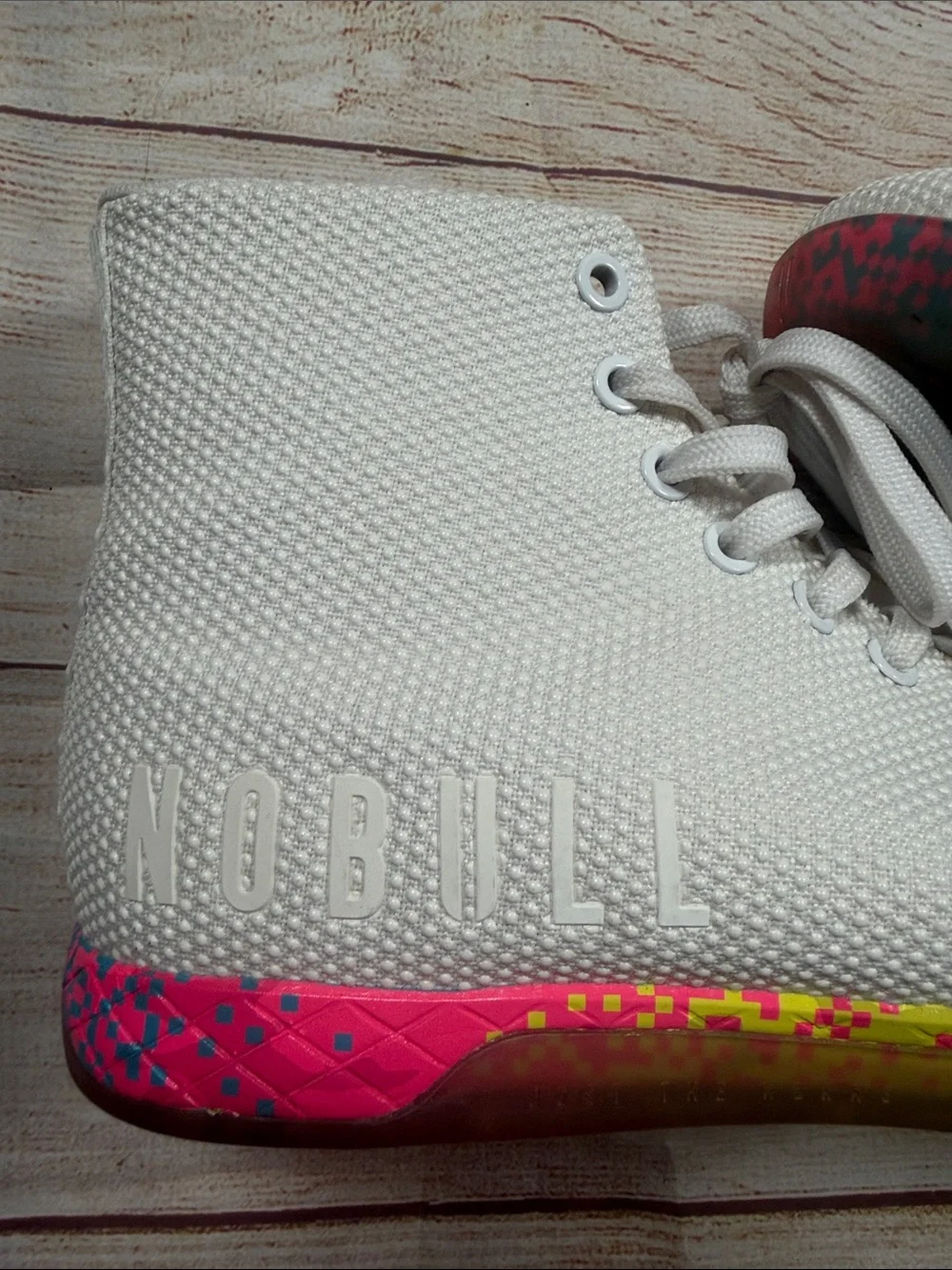 NOBULL‎ white high-top trainers featuring a vibrant multi-color glitch sole